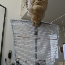 In this image of the FRANKLIN D. ROOSEVELT sculpture, you can see the armature as the artist works on the sculpture's clay state.