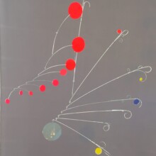 This mobile is titled "CELESTIAL II." The artist used aluminum and balsa wood materials to accomplish this piece.