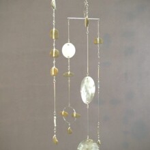 This mobile, "MEDITATIONS III," uses aluminum, steel, and pebble.