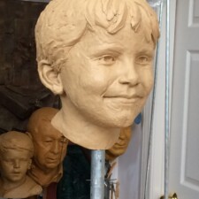 Commissioned portrait sculpture of child named MATTHEW for a private collection. This image is of the sculpture in progress, in its clay state.
