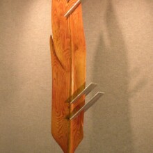 This feather in Richard Pumphrey's gallery is titled "COMPROMISED X: THE CODE" and made with wood and aluminum.